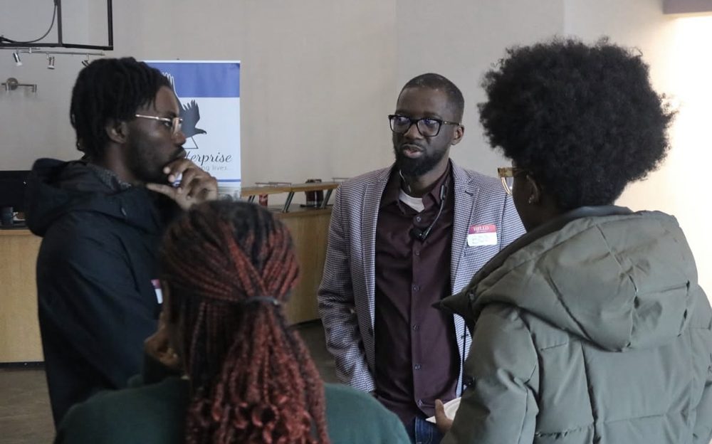 A mentor in conversation with young professionals